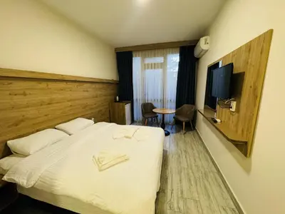 a hotel room with a bed and a television at Askoroz Otel İzmit in Izmit