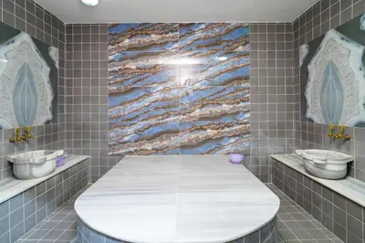 a bathroom with a white toilet and two sinks at Askoroz Otel İzmit in Izmit