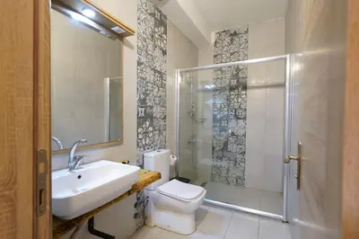 a bathroom with a toilet sink and a shower at Askoroz Otel İzmit in Izmit