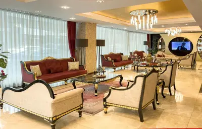 a living room with couches and tables and a television at The Conforium Hotel İstanbul in Istanbul