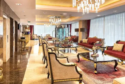 a lobby with chairs and tables in a building at The Conforium Hotel İstanbul in Istanbul
