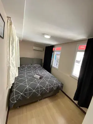 a bedroom with a bed in the corner of a room at ilkim&derin suite in Istanbul