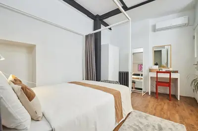 a bedroom with a white bed and a desk at Stunning Apartment at Unbeatable Location in Istanbul