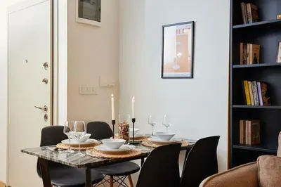 a dining room with a table with chairs and wine glasses at Stunning Apartment at Unbeatable Location in Istanbul