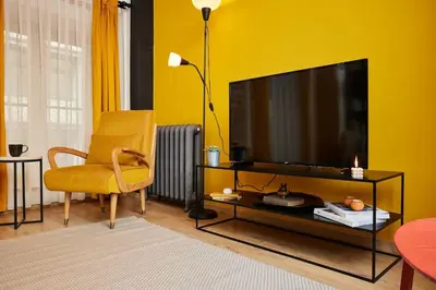 a living room with a television and a yellow wall at Stunning Apartment at Unbeatable Location in Istanbul