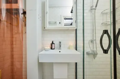 a bathroom with a sink and a glass shower at Stunning 2BR 1 Min Metro&Galata in Istanbul