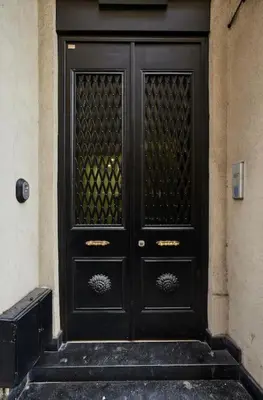 a black door on a building with steps at Stylish 2BR Apt Galata-Taksim Area Near Metro in Istanbul
