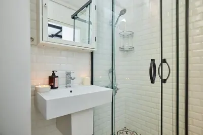 a bathroom with a sink and a glass shower at Modern 2BR Apt Galata-Taksim Area Near Metro in Istanbul