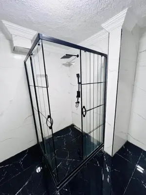 a glass door in a room with a white wall at Pembe Köşk Old City Center in Istanbul