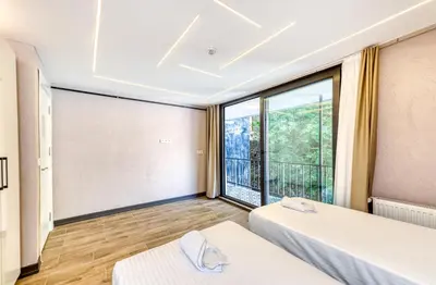 a room with two beds and a large window at Port Apart Hotel in Istanbul