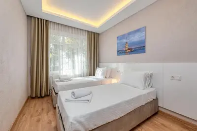 a hotel room with two beds and a window at Port Apart Hotel in Istanbul