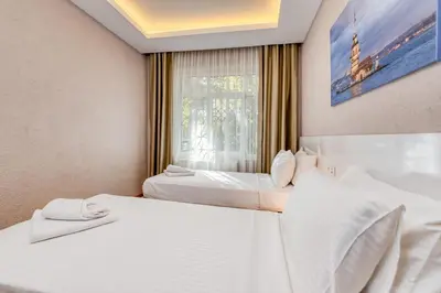 two beds in a room with a window at Port Apart Hotel in Istanbul