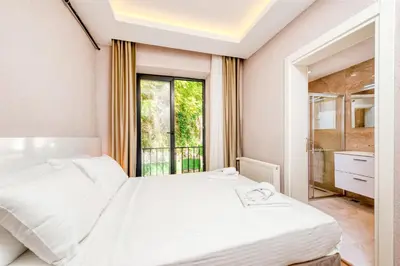 a bedroom with two beds and a window at Port Apart Hotel in Istanbul