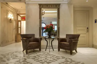 a hallway with two chairs and a table and a mirror at Taxim Lounge Hotel Special Category in Istanbul