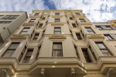 a tall white building with windows at Taxim Lounge Hotel Special Category in Istanbul
