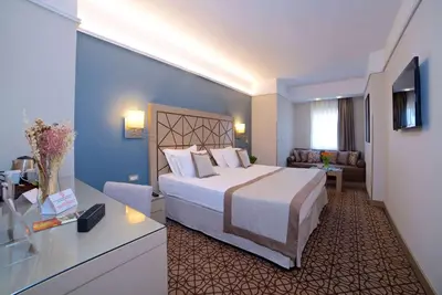 a hotel room with a large bed in a room at Ramada By Wyndham İstanbul Taksim in Istanbul