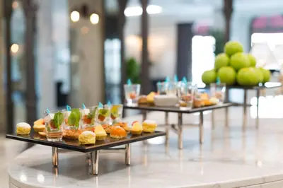 a row of tables filled with appetizers and fruit at Metropolitan Hotels Taksim in Istanbul