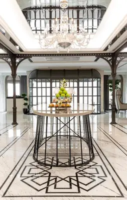 a large lobby with a table with fruit on it at Metropolitan Hotels Taksim in Istanbul