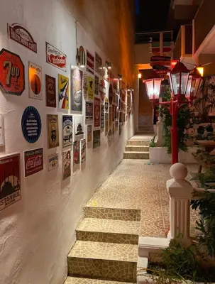 a hallway with stairs and posters on the wall at NO PROBLEM OTEL Pansiyon in Tekirdag