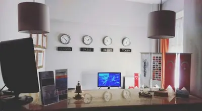 a room with a desk with a television and clocks at NO PROBLEM OTEL Pansiyon in Tekirdag