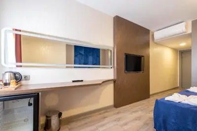 a hotel room with a bed and a tv at The Port Güzelyalı in Pendik