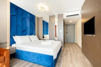 a hotel room with a large bed and a tv at The Port Güzelyalı in Pendik