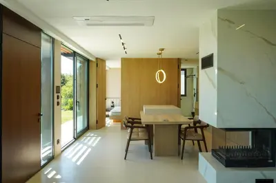 a kitchen and living room with a table and a fireplace at Beykoz Breeze in Beykoz