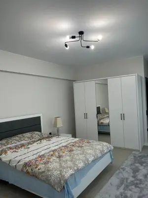 a bedroom with a bed and white cabinets at Havuzlu Villa-Kartepe in Masukiye