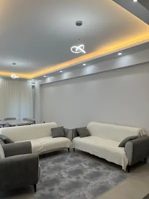 a living room with two couches and a white wall at Havuzlu Villa-Kartepe in Masukiye