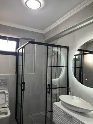 a bathroom with a sink and a shower and a mirror at Havuzlu Villa-Kartepe in Masukiye