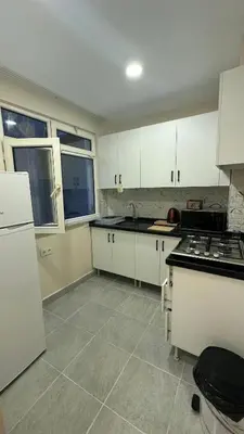 a kitchen with white cabinets and white appliances at Albatros suite in Istanbul