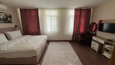a bedroom with a bed and a flat screen tv at Albatros suite in Istanbul