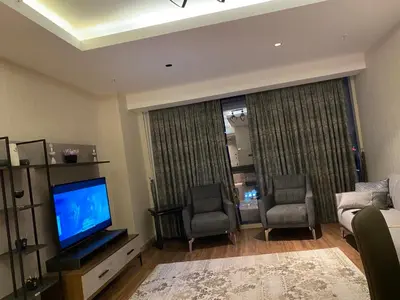 a living room with two chairs and a television at Low Price Luxury Apartment Perfect for An Amazing stay In ISTANBUL in Istanbul