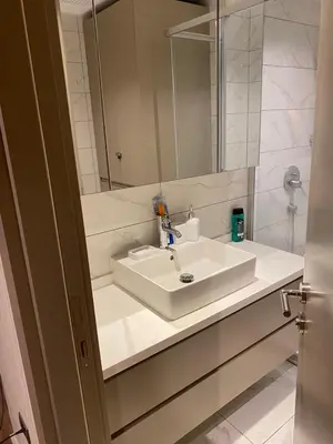 a bathroom with a white sink and a mirror at Low Price Luxury Apartment Perfect for An Amazing stay In ISTANBUL in Istanbul