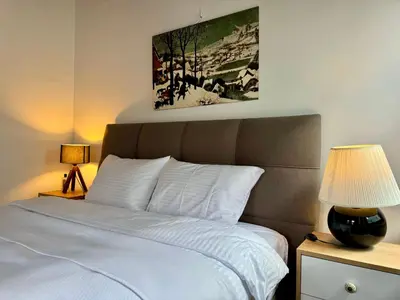 a bedroom with a bed and a painting on the wall at The Wooden 17 in Istanbul