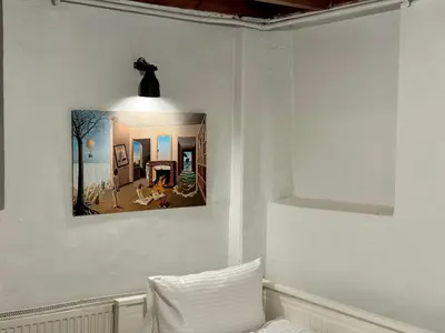 a wall with a picture of a living room at The Wooden 17 in Istanbul