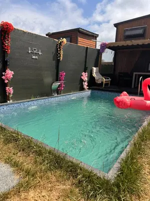 a swimming pool with a pool noodle in a backyard at Kackar Kamp istanbul in Domalı