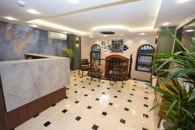 a lobby with a counter and chairs and a table at THE MUA LUXURY HOMEs in Istanbul