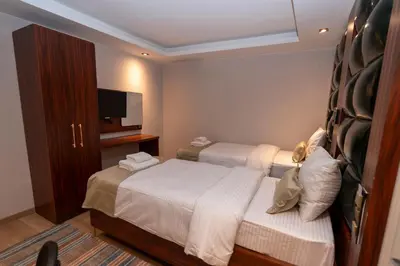 a hotel room with two beds and a television at THE MUA LUXURY HOMEs in Istanbul