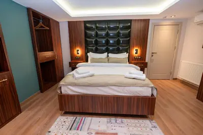 a bedroom with a large bed with a black headboard at THE MUA LUXURY HOMEs in Istanbul