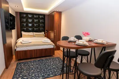 a bedroom with a bed and a table and chairs at THE MUA LUXURY HOMEs in Istanbul