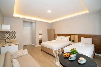 a hotel room with two beds and a couch at New Life Taksim Apart Hotel in Istanbul