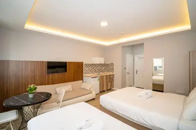 a living room with two beds and a table at New Life Taksim Apart Hotel in Istanbul