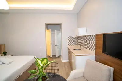 a living room with a couch and a tv in a room at New Life Taksim Apart Hotel in Istanbul
