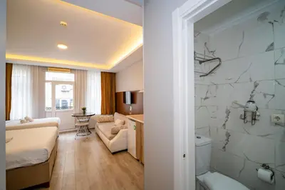 a hotel room with a bed and a bathroom at New Life Taksim Apart Hotel in Istanbul