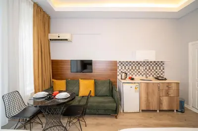 a living room with a green couch and a table at New Life Taksim Apart Hotel in Istanbul
