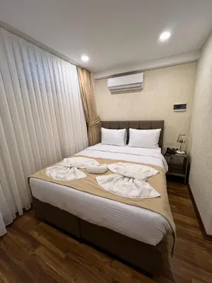 a bedroom with a large bed with towels on it at Nacre 360 in Istanbul