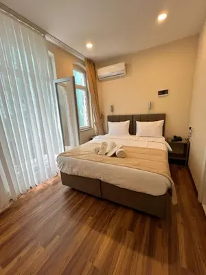 a bedroom with a large bed with wooden floors at Nacre 360 in Istanbul