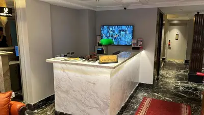 a lobby with a white counter and a television at Espoir HOTEL in Istanbul