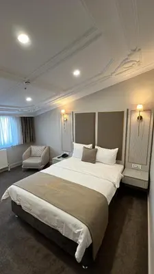 a hotel room with a large bed and a chair at Espoir HOTEL in Istanbul